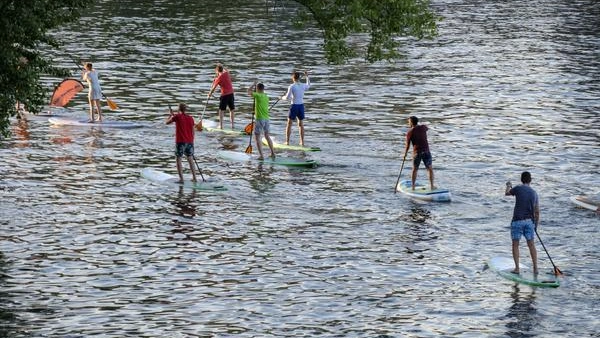Bild zeigt mehrere Personen beim Stand-Up-Paddling.